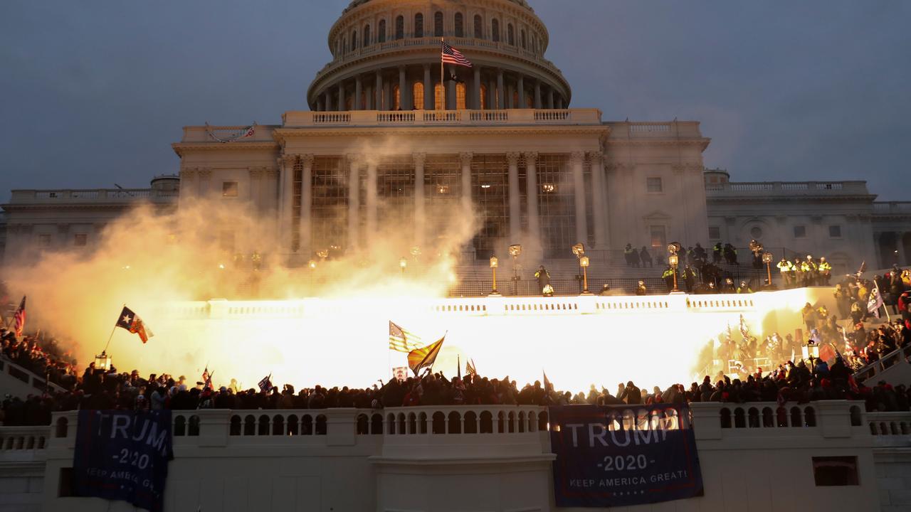 An explosion caused by a police munition is seen while supporters of Donald Trump gather in front of the Capitol Building. Picture: Reuters/Leah Millis