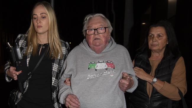 Former Olympic swim coach Dick Caine (centre) with his wife Jenny (right) and a lawyer in June last year after being granted bail in Bankstown Local Court. Picture: Monique Harmer