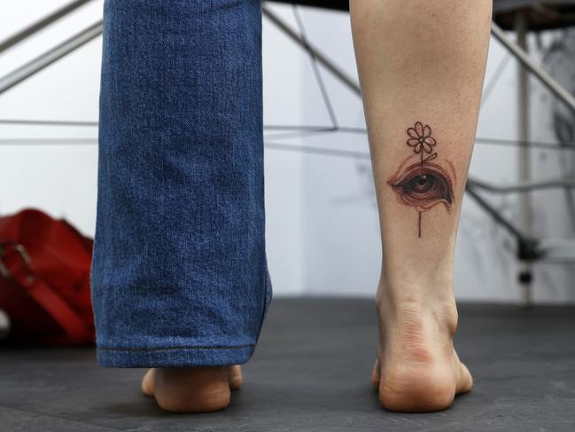 Sydney woman Stephanie Callanan, from the Northern Beaches, was gifted her very first tattoo — an artwork depicting ‘Beauty in the eye of the beholder’. Picture: Jonathan Ng