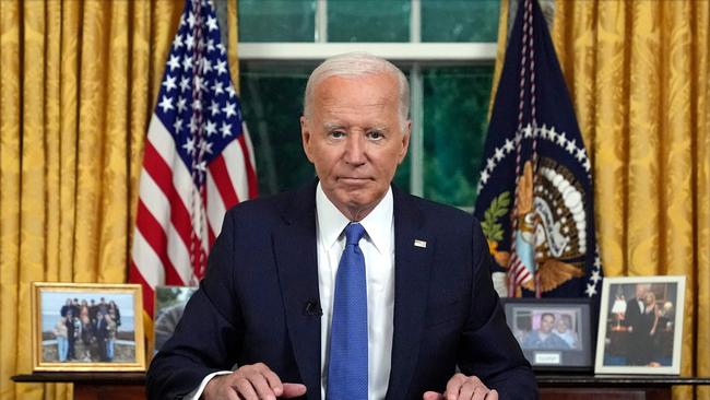 US President Joe Biden pauses as he concludes his address to the nation about his decision to not seek re-election in the Oval Office.