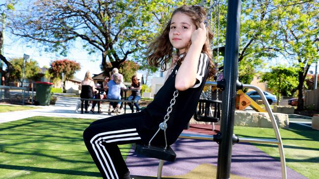 Ellen Nikolakopoulos, 9, plays at the Irving Street Reserve in Parramatta, not far from the boarding house. Picture: Angelo Velardo