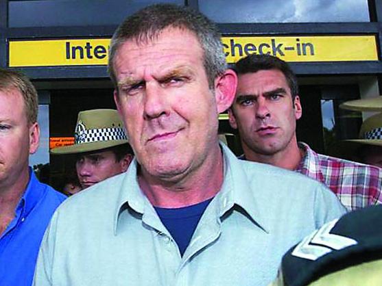 TWAM-20183006 EMBARGO FOR TWAM 30 JUNE 2018NO REUSE WITHOUT PERMISSION14/12/2005 WIRE: Bradley John Murdoch (C) surrounded by police arrives at Darwin airport from Adelaide 24 November 2003. One of Australia's most enduring crime mysteries came to an end 13 December 2005 when a mechanic and admitted drug runner, Bradley John Murdoch, was found guilty of the 2001 murder of missing British tourist Peter Falconio. Murdoch, 47, was also found guilty by a jury in the Northern Territory Supreme Court of assault and the attempted abduction of Falconio's English girlfriend, Joanne Lees, on a moonless night in remote central Australia. AFP PHOTO/David HANCOCK