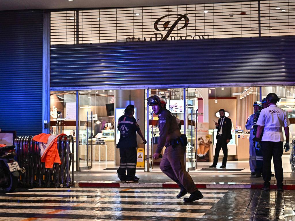 Police officers and rescue workers outside Siam Paragon shopping centre in Bangkok, where the boy allegedly opened fire. Picture: Lillian Suwanrumpha/AFP