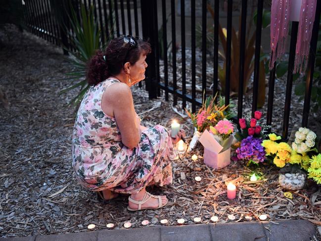 Cheryl-Lee Francis lights a candle at the shrine for Shae outside The Hub at Hervey Bay. Photo: Cody Fox