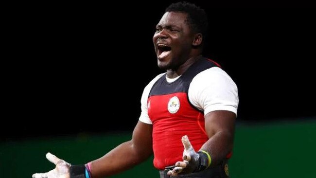 Petit David Minkoumba of Cameroon celebrates during the men's 94kg weightlifting final. Picture: Getty