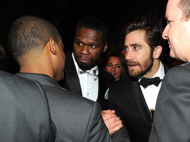 Didn’t know they were mates ... Jake Gyllenhaal and 50 Cent form a huddle at the Weinstein party.