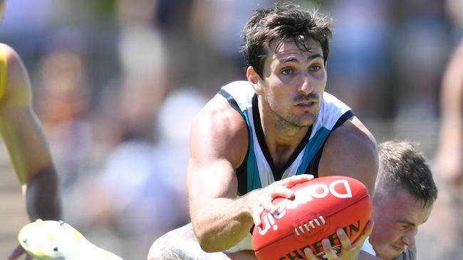 Port Adelaide’s Sam Mayes dishes out a handball in the trial against the Crows. Picture: David Mariuz (AAP)