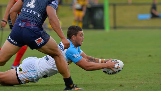 Ash Taylor scores a try for the Titans against the Warriors.