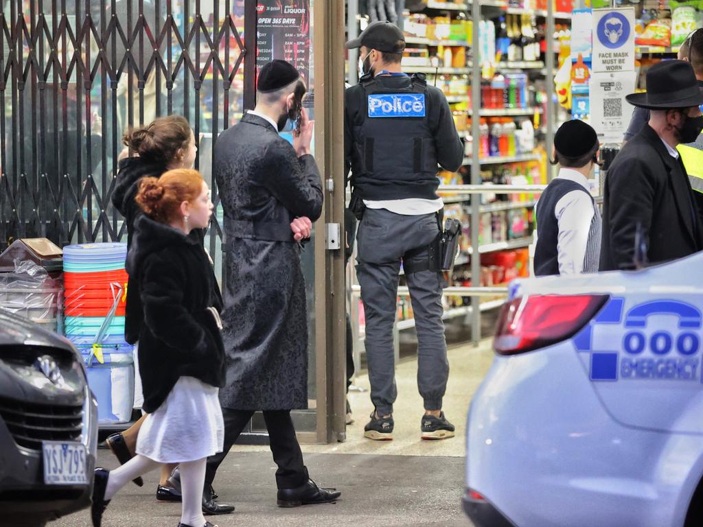 Police and onlookers outside an illegal gathering at the Adass Israel Synagogue in Ripponlea. Picture: Mark Stewart