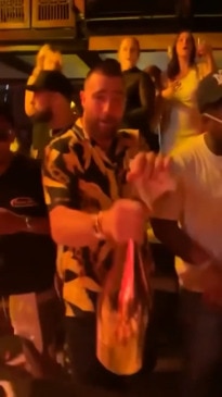 Travis Kelce swigs champagne from the bottle during Vegas trip