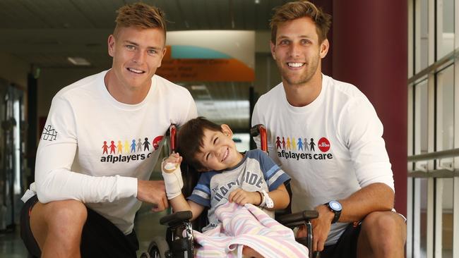 Giants players visited the Starlight Room at The Children's Hospital at Westmead. Adam Tomlinson and Matt de Boer dropped in on Luke Nikolic, 4. Picture: David Swift.