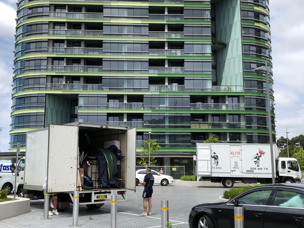 Removalists help residents return to Opal tower at Sydney Olympic Park.