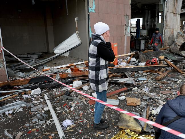 A woman reacts as she looks on at the destruction caused when a civilian building was hit by a Russian missile in Lviv, Ukraine. Picture: Getty Images