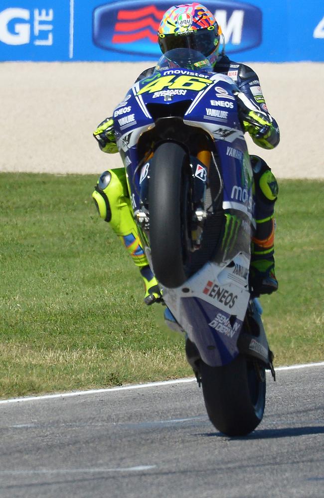 Valentino Rossi performs a wheelie in celebration after winning in San Marino