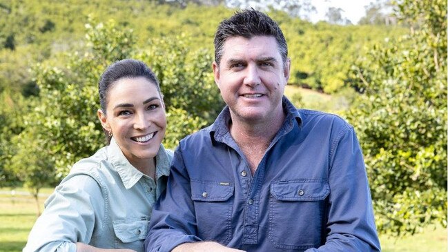 A picture of Giaan &amp; her Husband, Sam, leaning over a fence on their macadamia farm. Photo: Instagram @giaan.rooney