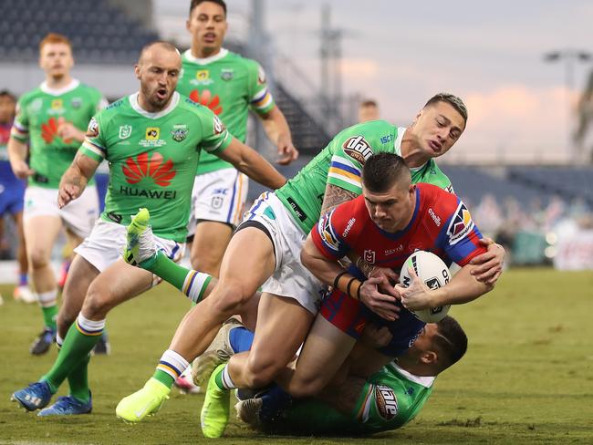 Bradman Best of the Knights barges through the Raiders to scores his first try of the match. Picture: Mark Kolbe/Getty Images