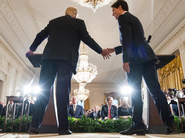 US President Donald Trump and Canada's Prime Minister Justin Trudeau shake hands during a joint press conference in the East Room of the White House on February 13, 2017 in Washington, DC. / AFP PHOTO / MANDEL NGAN