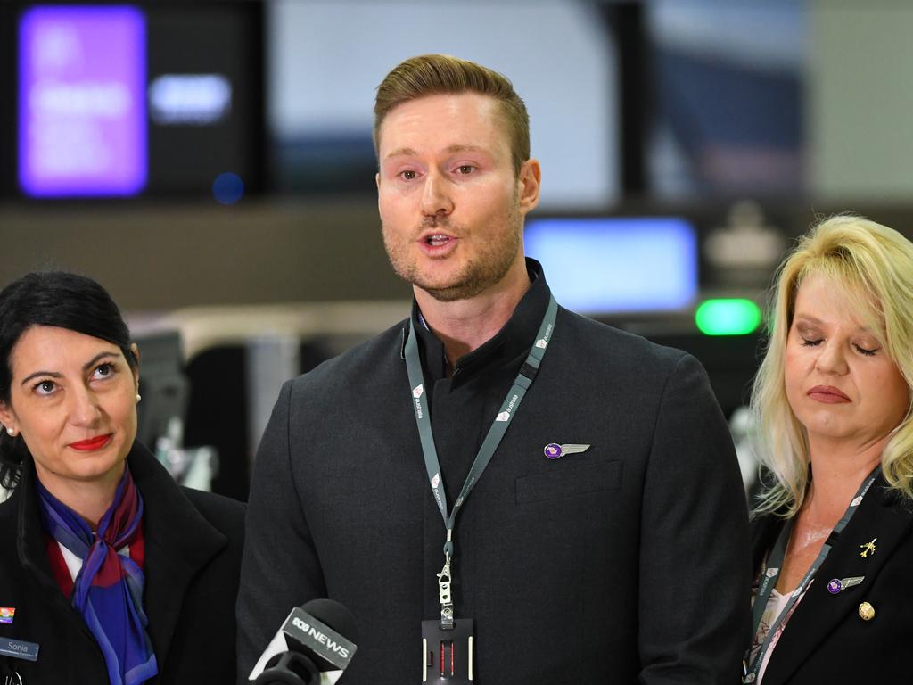 Virgin Australia employee Tony Smith (centre) speaks to the media during a press conference at Melbourne Airport in Melbourne. Picture: James Ross