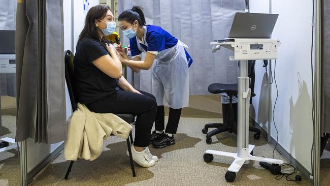 Anniina Pitkaenen receives a Covid jab at a mass vaccination centre at the Melbourne Showgrounds on Tuesday. Picture: Aaron Francis