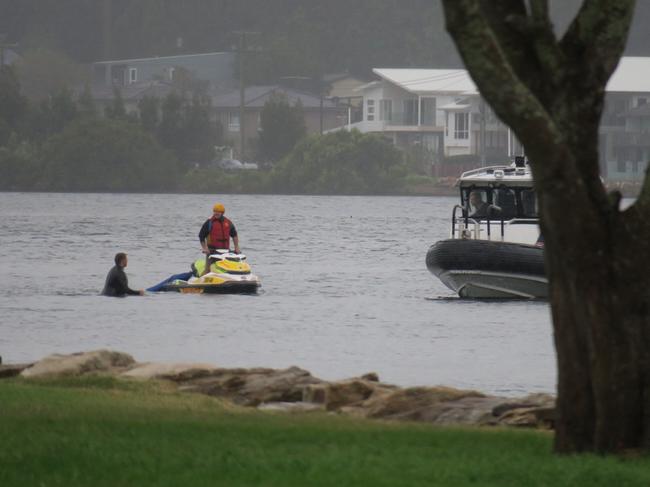 Police are being assisted by a Surf Life Saving jet ski. Picture: Richard Noone