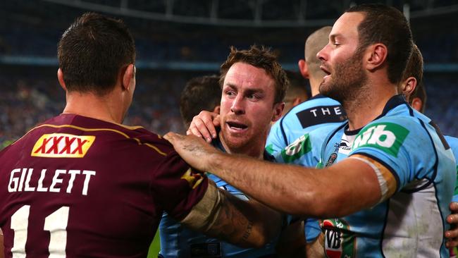 James Maloney of the Blues confronts Matt Gillett of the Maroons.