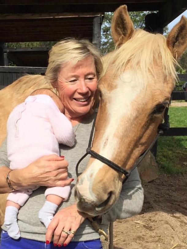 Christa with her horse, Fancy, and granddaughter Eddison.