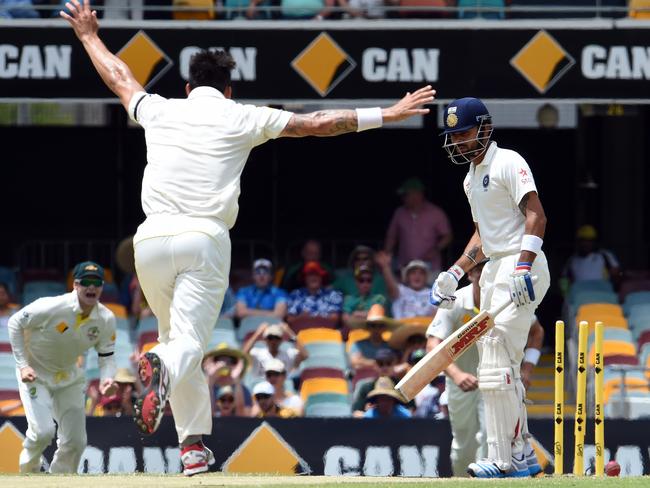 India's Virat Kohli is bowled off Australia's paceman Mitchell Johnson. Kohli was hit on the wrist in an earlier nets session.