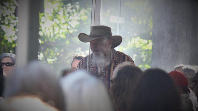 Uncle Mark Flanders walks through the crowd during a smoking ceremony at a citizenship ceremony in 2021. Photo: Tim Jarrett