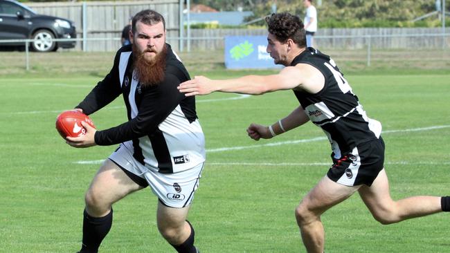 Claremont’s Jackson Simpson attempts to avoid Rohan Thomason (New Norfolk) last weekend. Picture: David Harding