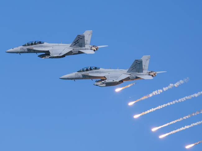An Air Force F/A-18F Super Hornet and EA-18G Growler fly in formation during a handling display at Nobby's Beach, as part of the Newcastle Williamtown Air Show 2023. *** Local Caption *** The Royal Australian Air Force (RAAF) in partnership with the City of Newcastle and Port Stephens Council delivered the Air Force Newcastle Williamtown Air Show 2023 over the weekend of 18 and 19 November 2023. The free community event on Saturday 18 November included morning and afternoon flying displays by RAAF aircraft overwater of Newcastle beaches and rivers. On Sunday 19 November, RAAF Base Williamtown opened its gates for an Open Day featuring static ground displays and a range of military equipment from across the Australian Defence Force. Newcastle Williamtown Air Show was proudly presented to continue to build on the relationship between Air Force and the local RAAF Base Williamtown community.