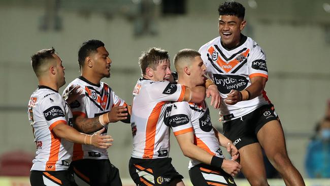 Adam Doueihi of the Tigers celebrates with teammates after scoring a try against Manly at Lottoland on Saturday. Picture: Getty Images