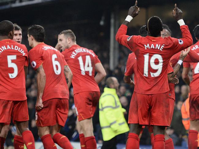 Liverpool's Senegalese midfielder Sadio Mane celebrates scoring his team's first goal during the English Premier League football match between Everton and Liverpool at Goodison Park in Liverpool, north west England on December 19, 2016. / AFP PHOTO / Oli SCARFF / RESTRICTED TO EDITORIAL USE. No use with unauthorized audio, video, data, fixture lists, club/league logos or 'live' services. Online in-match use limited to 75 images, no video emulation. No use in betting, games or single club/league/player publications. /