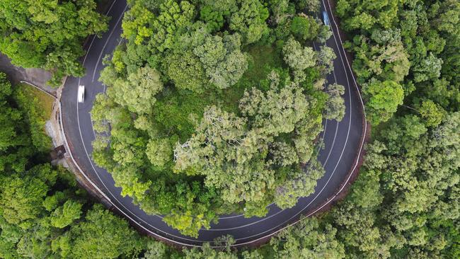 Aerial view of the Kennedy Highway snaking through World Heritage listed rainforest up the McAllister Range. This section of the highway is commonly referred to as the Kuranda Range Road, and is the main transport route from Cairns to the Atherton Tablelands, west to the Gulf and north to Cape York. Thousands of cars, tourist coaches and trucks traverse the Kuranda Range Road each day. The route can be hazardous in wet weather, with the roadway becoming slippery and trees and rocks commonly falling over the road. Picture: Brendan Radke