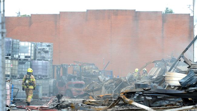 Fire crews mop up at the scene after a factory fire at Thornycroft Street Campbellfield. Picture: Andrew Henshaw