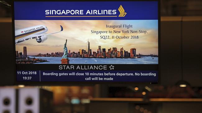 A screen advertising Singapore Airline's inaugural non-stop flight to New York at Changi International Airport.