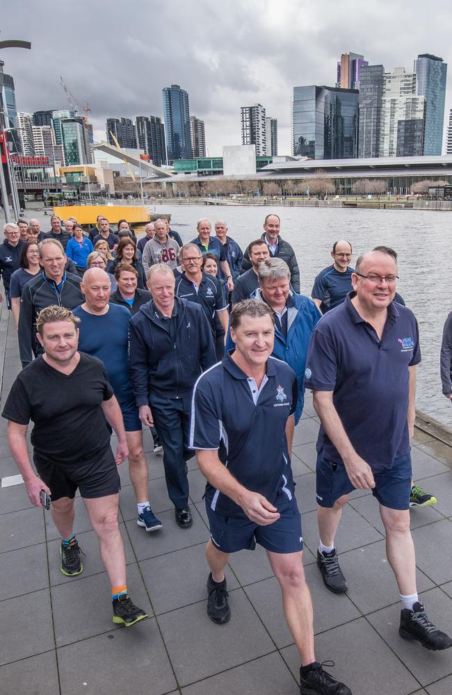 Deputy Commissioner Shane Patton (front left) strides out alongside Mr Ashton (front right) with members of the Victoria Police command team behind them. Picture: Jason Edwards