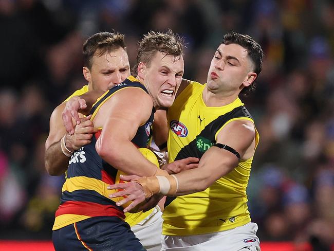 Jordan Dawson fights off a tackler. (Photo by James Elsby/AFL Photos via Getty Images)