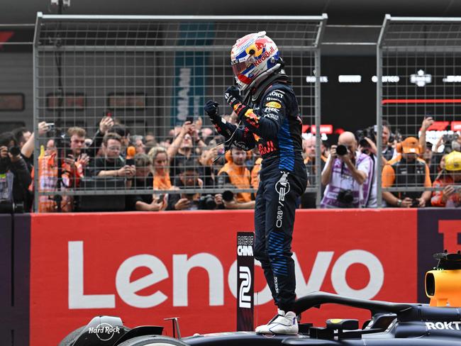 Dutch driver Max Verstappen celebrates after winning the Chinese Grand Prix. (Photo by HECTOR RETAMAL / AFP)