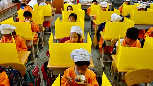 Students eat their lunch on desks with plastic partitions at Dajia Elementary School in Taipei. Taiwan. Picture: AFP