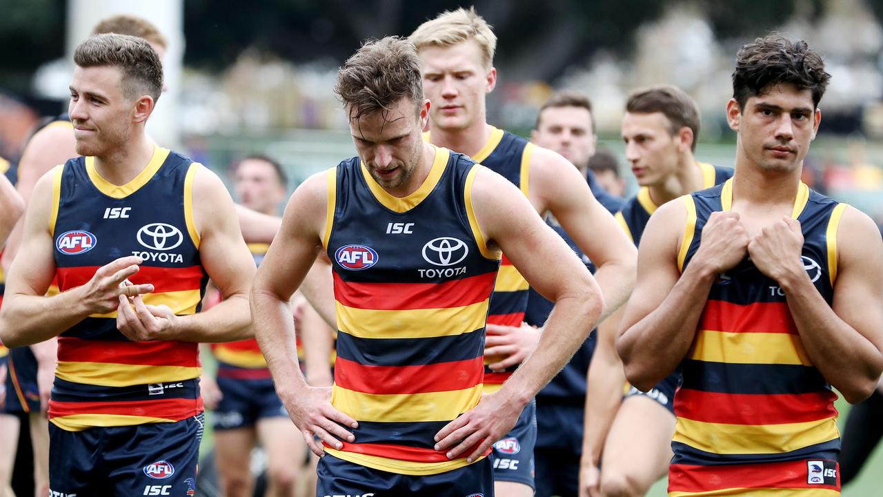 Paul Seedsman, Brodie Smith and Shane McAdam lead the Crows off the field after the Essendon loss. Picture: Sarah Reed