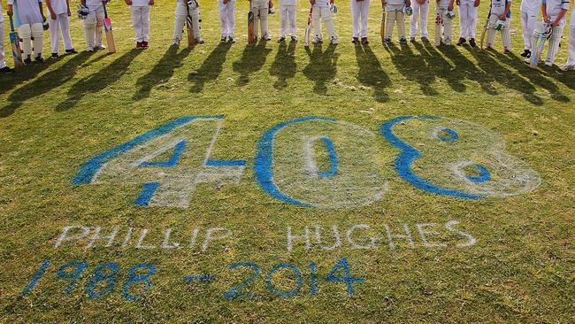 Langwarrin and Somerville cricketers stand for a minute’s silence in Melbourne. Picture: Michael Dodge/Getty Images)