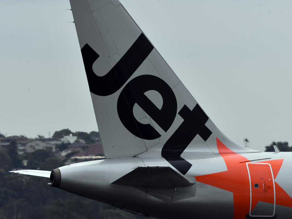 SYDNEY, AUSTRALIA - DECEMBER 12: A Jetstar aircraft tail is seen on arrival at Sydney airport on December 12, 2019 in Sydney, Australia. Jetstar has cancelled 108 upcoming flights between Friday and Sunday in preparation for pilots and ground staff to walk off the job for four hours on Saturday and Sunday amid stalled wage negotiations. (Photo by Sam Mooy/Getty Images)