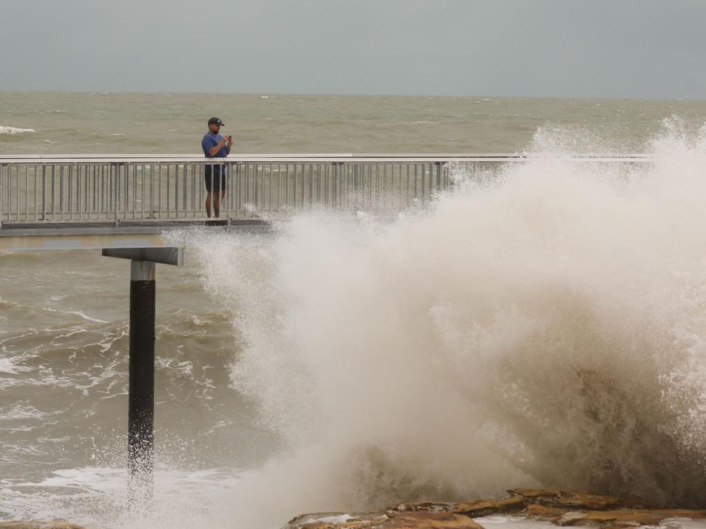 A typical Top End wet season scene. A man spectates mother nature and her power from the safety of the Nightcliff jetty. Picture: Glenn Campbell.