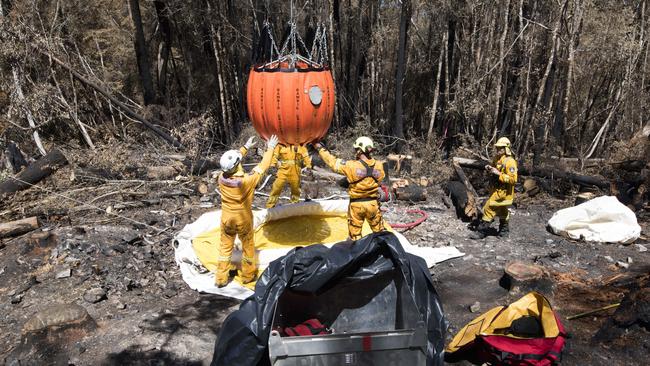 Gell River fire fighters prepare a bucket for aerial firebombing. Picture: WARREN FREY