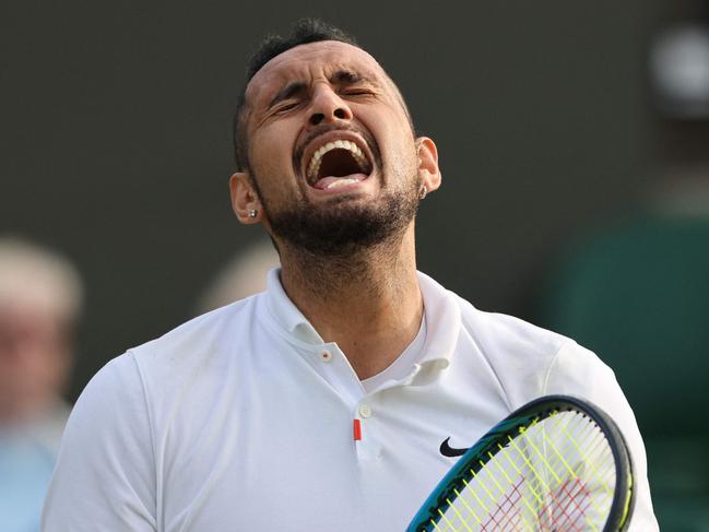 Australia's Nick Kyrgios reacts to hitting the ball into the net in the match against Italy's Gianluca Mager at their men's singles second round match on the fourth day of the 2021 Wimbledon Championships at The All England Tennis Club in Wimbledon, southwest London, on July 1, 2021. (Photo by Adrian DENNIS / AFP) / RESTRICTED TO EDITORIAL USE