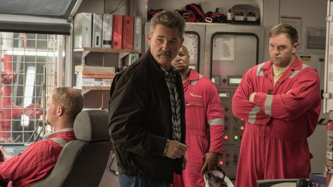 This image released by Summit shows Kurt Russell, center, in a scene from, 
