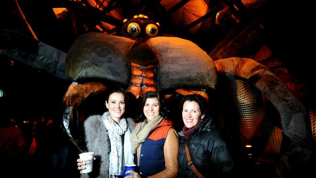 Amanda Jordan, of Auckland, Bridget Slocum, of Melbourne, and Gillian Slocum, of  West Hobart, place their fears in the ogoh-ogoh at Dark Park. Picture: FIONA HARDING