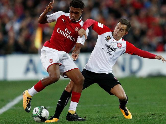 SYDNEY, AUSTRALIA - JULY 15:  Alex Iwobi of Arsenal is challenged by Steve Lustica of the Wanderers during the match between the Western Sydney Wanderers and Arsenal FC at ANZ Stadium on July 15, 2017 in Sydney, Australia.  (Photo by Zak Kaczmarek/Getty Images)