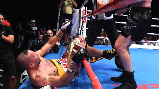 Anthony Mundine is knocked out of the ring during his defeat to John Wayne Parr. Picture: AAP