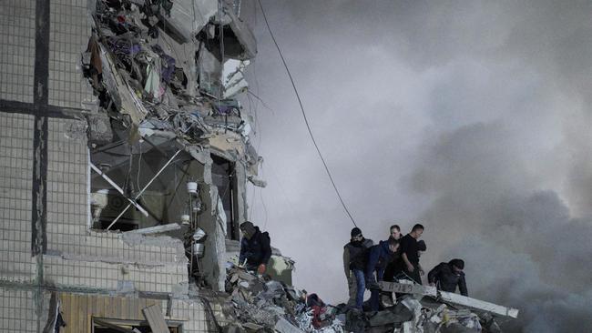 Civil defence workers search for survivors in a residential building hit by a Russian missile strike in Dnipro on Saturday. Picture: AFP